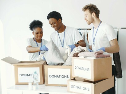 Volunteers sorting donated essentials, representing the power of improving individual lives through collective action