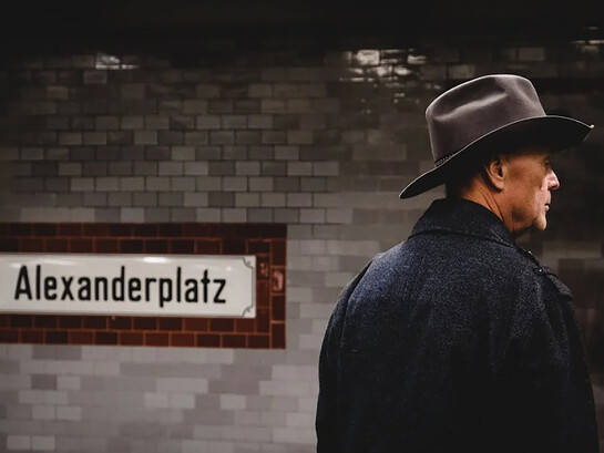 Man wearing a cowboy hat and black coat, seen from behind, Berlin, Germany