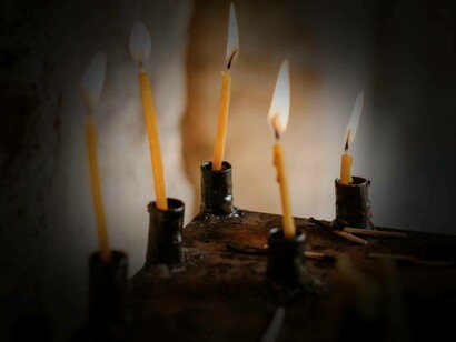 Candele illuminano l'interno di una chiesa
