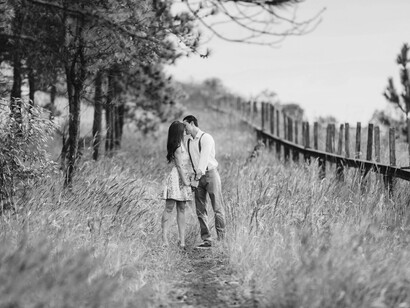 A couple kisses on a field
