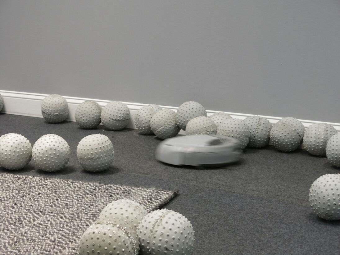 Nadim Abbas, Zone I, 2014. 
Lightweight concrete casts, robotic vacuum cleaner, rug, skirting board, house paint. Dimensions variable.