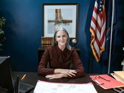 A poised woman at her desk in a political office, symbolising the growing presence of women in positions of power