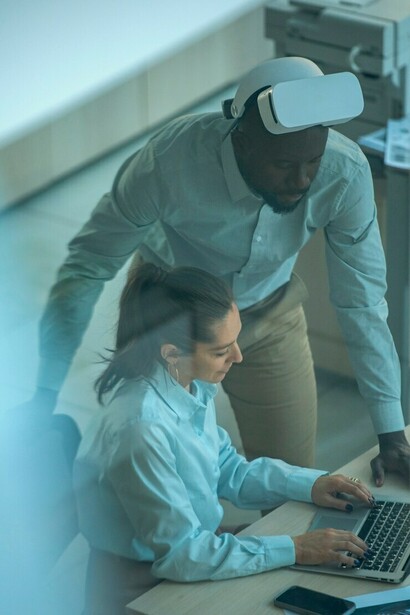 Industrial designers working on a 3D model, showcasing AI integration in the workplace, highlighting human-AI collaboration, and illustrating the future of automation in industries
