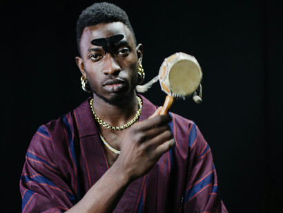 A young man with a hand drum