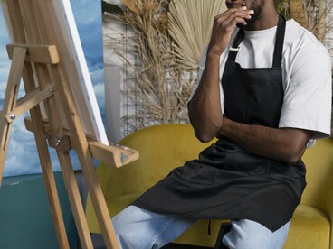 An African artist painting, representing the evolution of traditional creativity into contemporary artistic expression