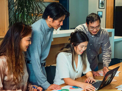 In a bright and collaborative office, the team shares smiles and ideas, reinforcing the importance of connection in combating burnout