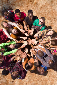 People joining hands and looking upward, diverse groups embracing, helping one another, and engaging in social inclusion activities