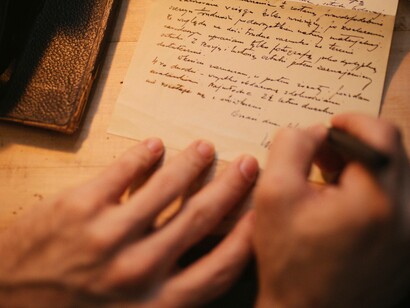 Signing his name to his love letter
