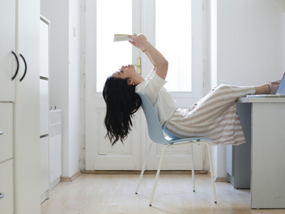 A girl reads a book at her desk