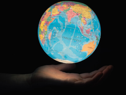 Balancing the globe of the world on one hand