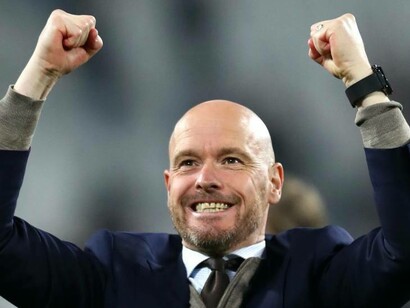 Erik ten Hag celebrating a victory for his team with hands in the air