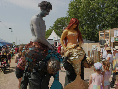 Walkabout artists engaging festivalgoers at the Glastonbury Festival in England