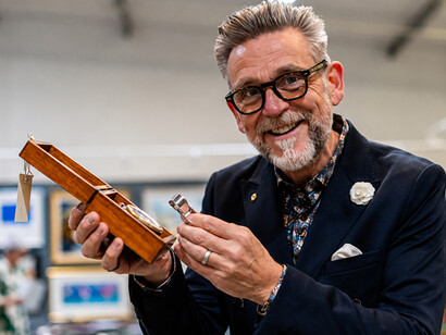 Experienced watch dealer carefully examining a vintage clock mechanism
