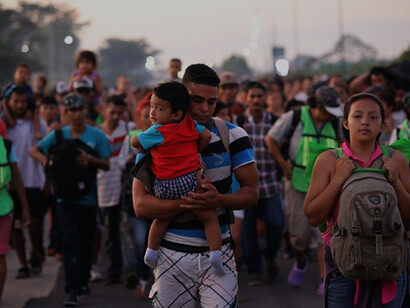 Members of a migrant caravan walk into the interior of Mexico