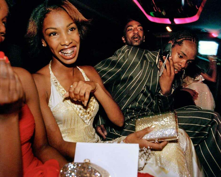  Crenshaw High School girls selected by a magazine to receive “Oscar treatment” for a prom photo shoot take a limo to the event with their dates, Culver City, California, 2001. © Lauren Greenfield
