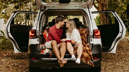 A couple in the trunk of the car are dismissing the talk of marriage and kids on a date