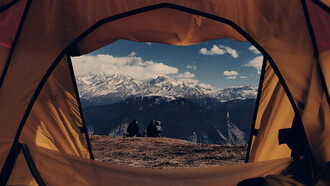 A view from a brown dome tent overlooking the Himalayas in Nepal