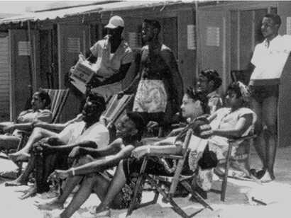 Beach bathers sit on the beach in Virginia Key Beach