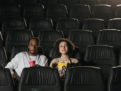 An AI screenwriter creating a script, surrounded by holographic storyboards and digital text