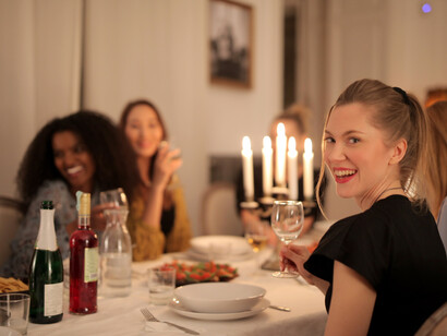 Friends smile for the camera at a dinner party honoring their friend