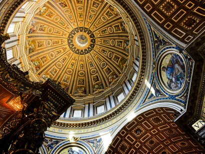 The monumental bronze Baldachin of St. Peter's Basilica in Vatican City stands beneath Michelangelo's iconic dome, framed by soaring columns, elaborate frescoes, and exquisite Baroque ornamentation