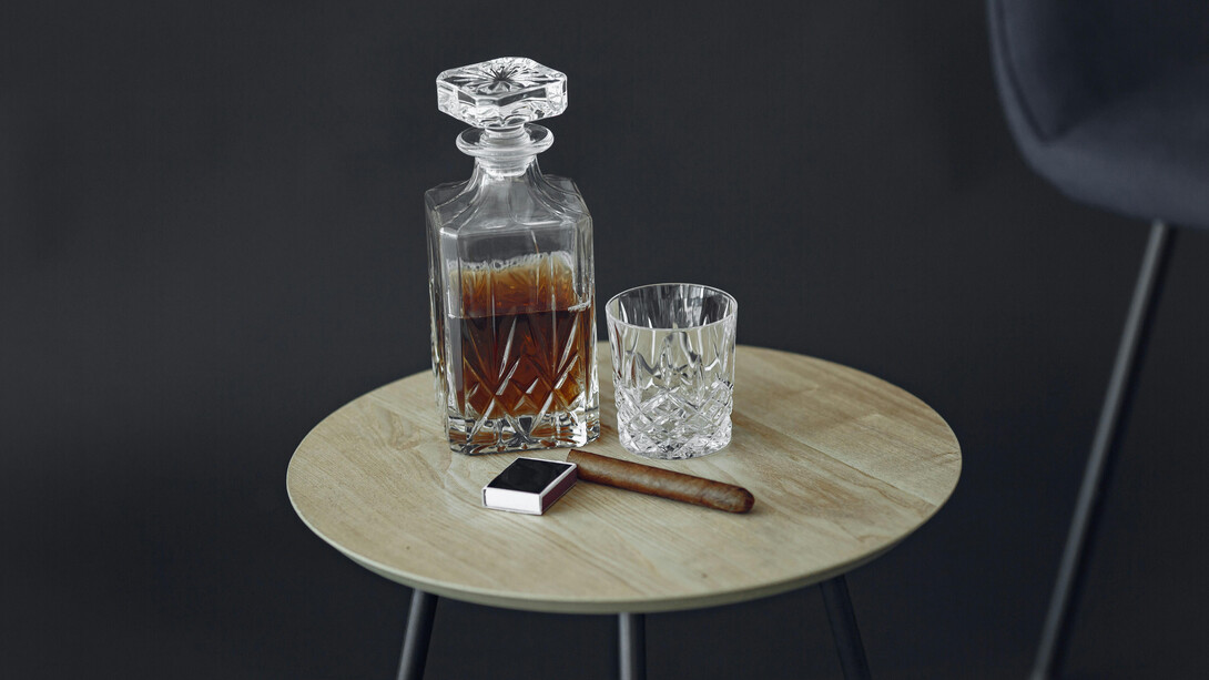 An engraved bottle of bourbon and a cigar, symbols of status