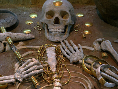 The Varna Necropolis, discovered in 1976 and dated to the 5th millennium BCE, contains graves with the earliest known worked gold. One burial, believed to belong to a 35-year-old elite individual, included a golden scepter, large gold armbands, cloak fasteners, and copper and stone axes