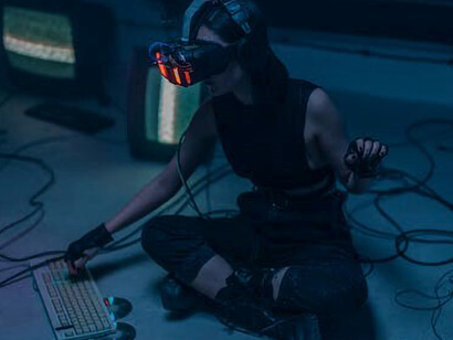 Seated on the floor, a woman was immersed in her fascination with technology and artificial intelligence, relishing every moment of it