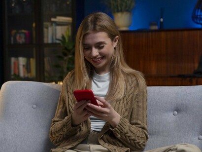 A lady scrolling through content recommendations, symbolising the personalised entertainment experiences powered by algorithms