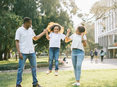 A family of three having a joyful time in the park
