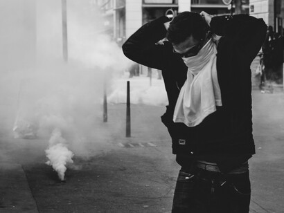 Protesters flee from the rising cloud of tear gas as tensions escalate in the streets