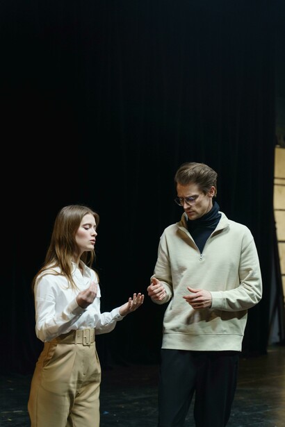 Rehearsals underway, with people holding scripts of the play