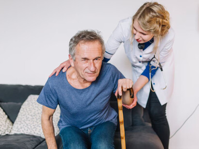 A stroke patient receiving care from a nurse in a retirement home