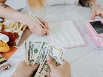 A woman sorting the budget from the funds she gathered for her start-up