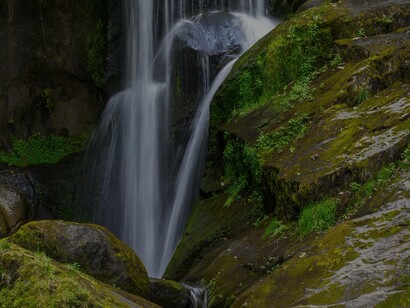 A flowing waterfall bathing the nearby rocks