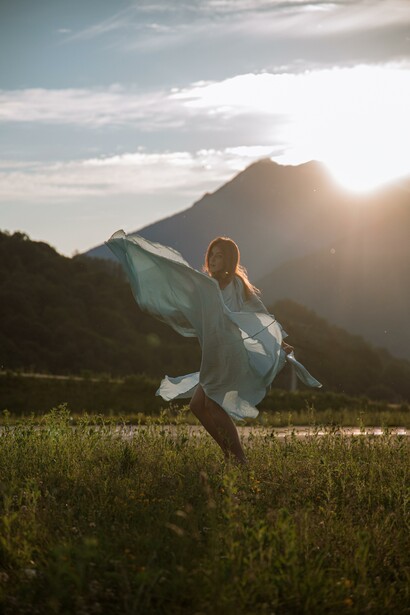 Person engaging in an activity that brings joy in a meadow 