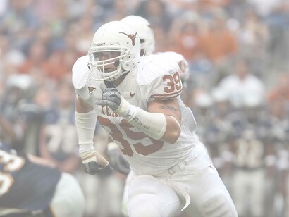 A college football player of the Texas Longhorns running a play in the hopes of scoring for his team