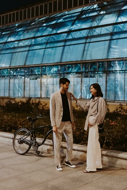 A couple having a thoughtful conversation while sitting on a quiet street