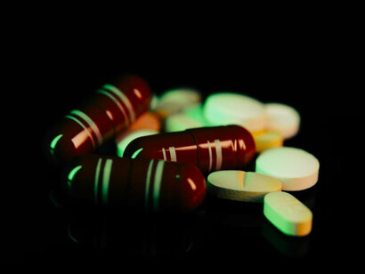 A close-up shot of a variety of multivitamin pills scattered across a table