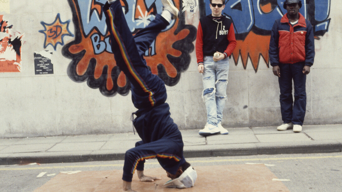 Beezer, Bristol BBoys head spinning in front of 3D's and Z Boys’ Wild Bunch Rocit, 1983, photographic print on paper, Broadmead, Bristol, 21 x 29.7cm
