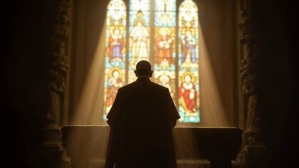 A silhouette bathed in light before the altar, symbolising hope for a church renewed by faith rather than commerce