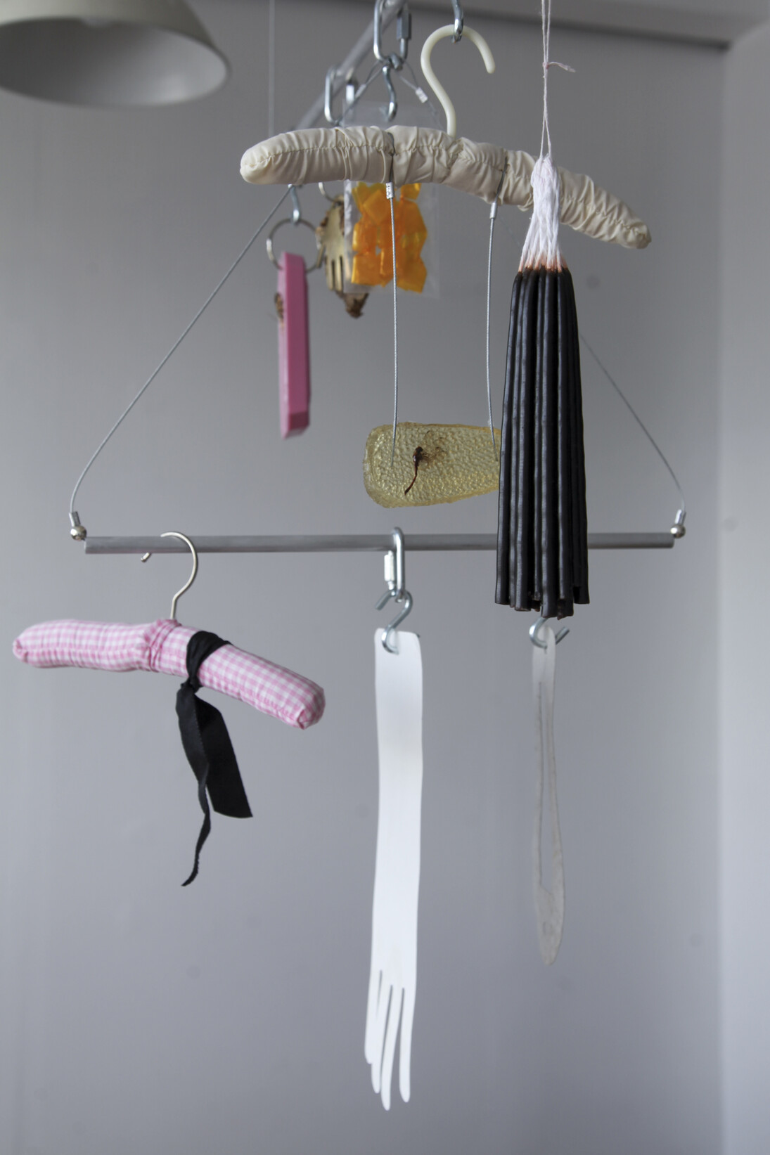 Mobile, Nadia Gohar, silicone mould, butterfly, sunflower, horse brass, gum arabic, dragonfly in cast resin, candles, clothing hangers, ribbon, found paper, steel rod, and wire rope, 2017. Courtesy of the artists