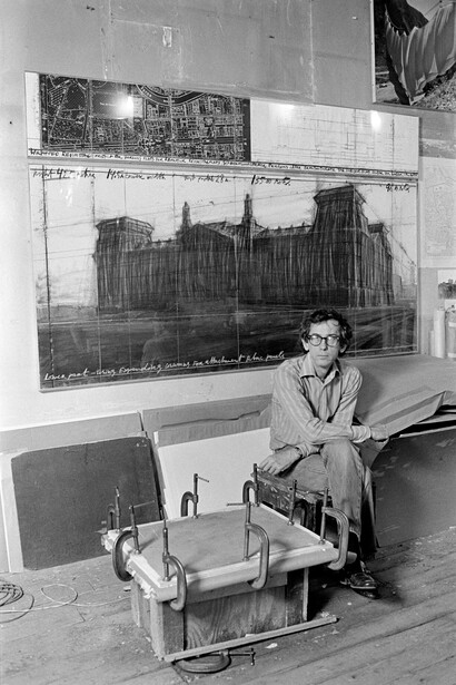 Christo in his studio with a preparatory drawing for Wrapped Reichstag, New York City, 1984. Courtesy of the National Gallery 