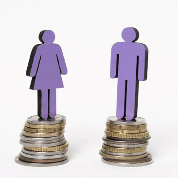 Man and woman standing on equal piles of coins