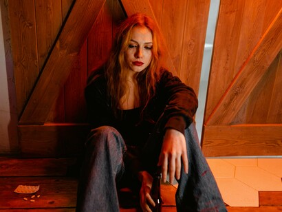 A woman consumed by intense sadness, representing the breaking point that comes before self-reconstruction