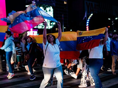 Buenos Aires, Argentina cheerful Venezuelans waving flags during a public celebration in the city streets