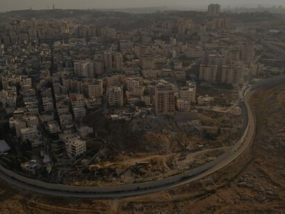 An aerial view reveals the stark division between Israel and Palestine by the imposing security wall