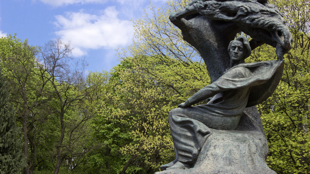 The statue of Frédéric Chopin is a large bronze sculpture designed by Wacław Szymanowski, located in the upper part of Warsaw’s Royal Baths Park, near Aleje Ujazdowskie