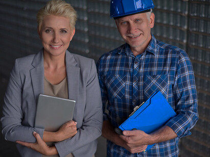 Two elderly workers in a warehouse, contributing to the senior workforce and demonstrating the role of older adults in the workplace