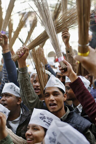 AAP followers waving brooms